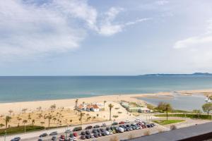 a view of a beach and a parking lot with cars at BLUE HOLIDAYS RELAX & VIEWS Sylvia12 in Empuriabrava +20 photos