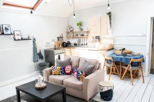 a living room with a couch and a table at Cute Self Catering Flat in the Brecon Beacons in Crickhowell