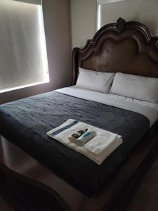 a bed with a tray with two items on it at Jule Sleep in Denver