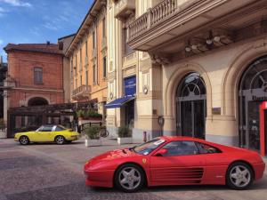 a red car parked in front of a building at Locanda San Paolo in Monza +68 photos
