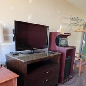 a desk with a large tv on top of it at Budget Inn Wentzville in Wentzville