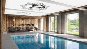 a pool in a room with chairs and a table at Auberge d'Aillon et d'Ailleurs in Aillon-le-Jeune