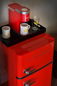 a red refrigerator with two cups on top of it at Foothills Motel in Auburn