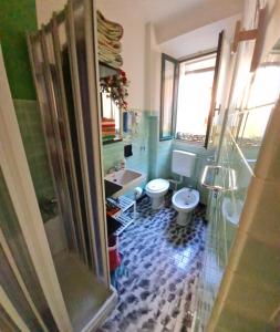a bathroom with a toilet and a sink at Gioco dell'oca in Ponna Superiore +57 photos