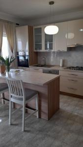 a kitchen with a large wooden table and a chair at MERICA Kneže in Korčula