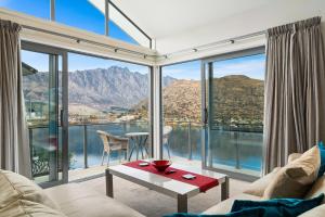 a living room with a view of the mountains at Lakeview Retreat - Queenstown Holiday Home in Queenstown