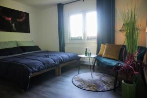 a living room with a couch and a table at EGE sleep & stay at Kassel - Fasanenweg in Kassel