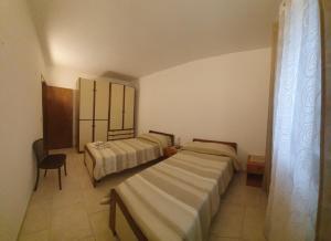 Ένα ή περισσότερα κρεβάτια σε δωμάτιο στο Villino zia Rosy
