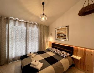 a bedroom with a bed with two towels on it at FatCow Beach House 43 in Larnaka