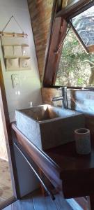 a stone sink in a bathroom with a window at DOMO ¨EL TIO JUAN¨ in Piriápolis