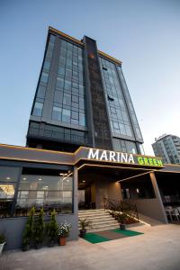 a large building with a marina city sign on it at Marina Green Suite & Residence in Trabzon