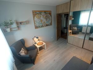 a living room with a couch and a table at Apartament Moris in Puck