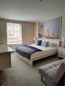 a bedroom with a large bed with a painting on the wall at St Johns Boutique Hotel in London