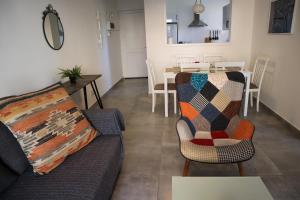 a living room with a couch and a table at Alex's Vacation Suite - 100m from the beach - 6 Guests in Paphos