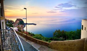 a view of the ocean from a balcony at Nel blu dipinto di blu in Scilla +8 photos