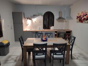 a kitchen with a table and chairs in a kitchen at Family Apartment Maria in Matulji