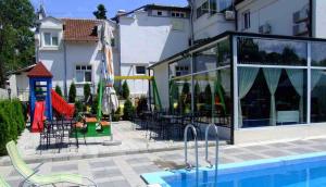 a resort with a pool and tables and chairs at Devedzic in Vrnjačka Banja