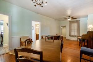 a dining room and living room with a table and chairs at Captains Quarters by the Bay cottage in Norfolk +32 photos