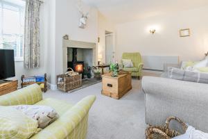 a living room with a couch and a fireplace at St John's Cottage in Penistone
