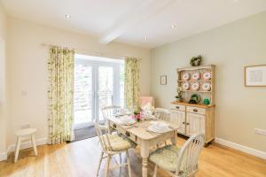 a dining room with a table and chairs at St John's Cottage in Penistone