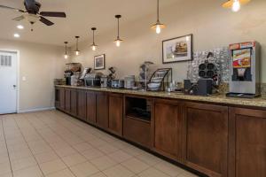 a food counter in a restaurant with a ceiling fan at Best Western Orchard Inn in Turlock