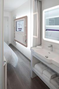 a bathroom with a white sink and a window at YOTEL Istanbul Airport, City Entrance in Istanbul
