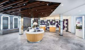 a lobby with a reception desk in a building at YOTELAIR Singapore Changi Airport Landside in Singapore