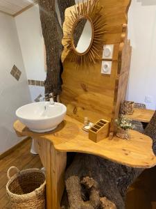 a bathroom with a sink and a mirror on a wooden table at Cabane Dans les Arbres, Domaine de l Ogliastru in Olmeto