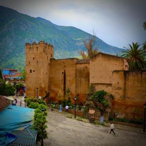 a group of people walking in front of a building at Dar el Khzana in Chefchaouene