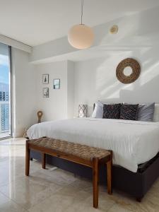 a bedroom with a large bed and a bench at Icon Brickell Miami in Miami +75 photos