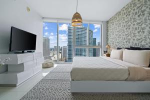 a bedroom with a large bed with a flat screen tv at Icon Brickell Miami in Miami