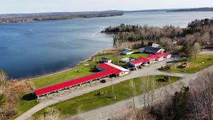 an aerial view of a building next to a lake at Trailsman Lodge in Baddeck