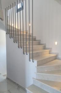a staircase with wooden steps and black railings at Blue diamonds villas Paros in Pounda