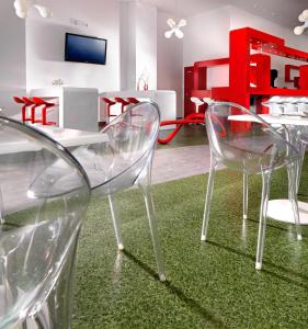 a room with two chairs and a table with a green rug at Airotel Patras Smart Hotel in Patra