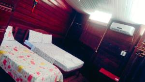 En eller flere senge i et værelse på Amazon Gero Tours