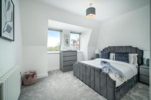 a bedroom with a large bed and a window at Luxury Brighton Apartments in Brighton & Hove