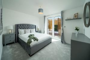 a bedroom with a bed with a teddy bear on it at Luxury Brighton Apartments in Brighton & Hove