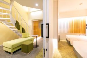 a room with a staircase and a bed at Tenza Hotel & SKYSPA at Sapporo Central in Sapporo