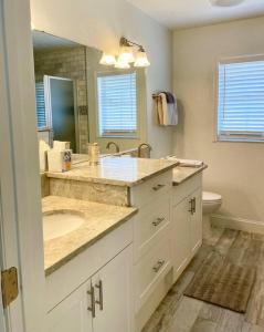 a bathroom with a sink and a mirror at Gulf to Golf. in Bradenton