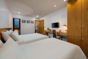 Postel nebo postele na pokoji v ubytování Hanoi Paon Hotel & Spa