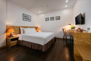 Postel nebo postele na pokoji v ubytování Hanoi Paon Hotel & Spa