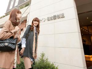 two young women standing outside of a building at Meitetsu Inn Nagoya Sakuradori in Nagoya