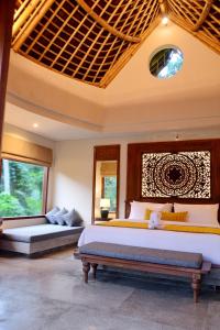 a bedroom with two beds and two windows at Kenran Resort Ubud By Soscomma in Ubud