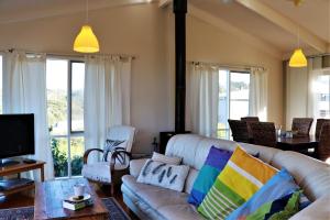 a living room with a couch and a tv at Marians in Aireys Inlet