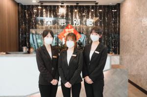 a group of three women in suits wearing masks at Xien Shi Homestay in Jinning