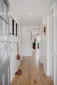 a hallway with white walls and wooden floors at Lillet on Short I King Beds I Stay Dubbo in Dubbo