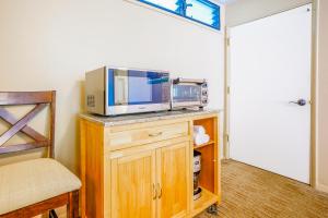 a microwave sitting on top of a counter in a room at Hale Moi #103B in Princeville