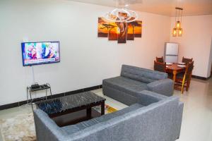 a living room with a couch and a table at BlueGreens Accommodation in Ndola