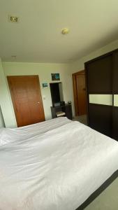 a bedroom with a white bed and a desk at Seaview Beachfront Maephim Beach A12 A13 in Rayong