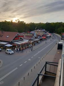 a street in a town with a car on the road at Apartamenty Donald in Krynica Morska